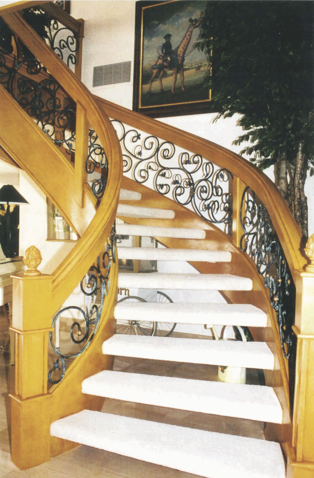 Reworked staircase and rail system, from black lacquer and lucite<br />to faux wood finish and custom iron work, view 2 - Palm City