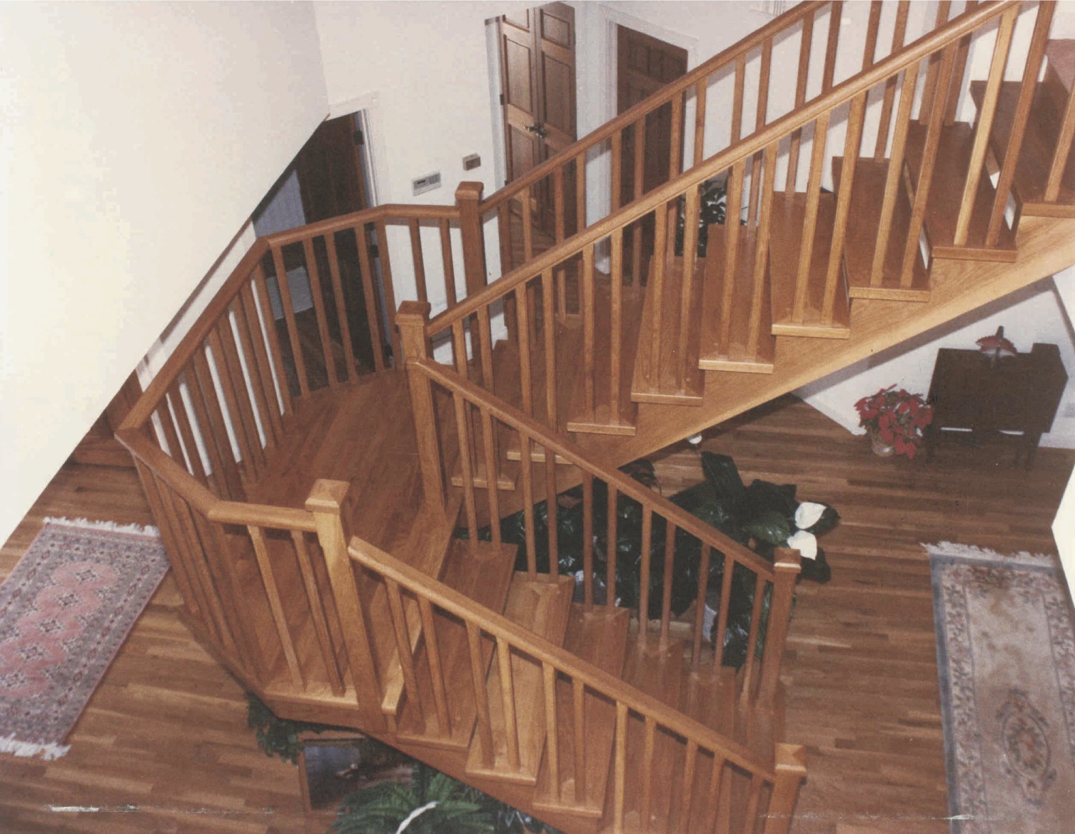 Two flight oak stairs with intermediate landing, deeply set in<br />double stringers - Bay St. Lucie