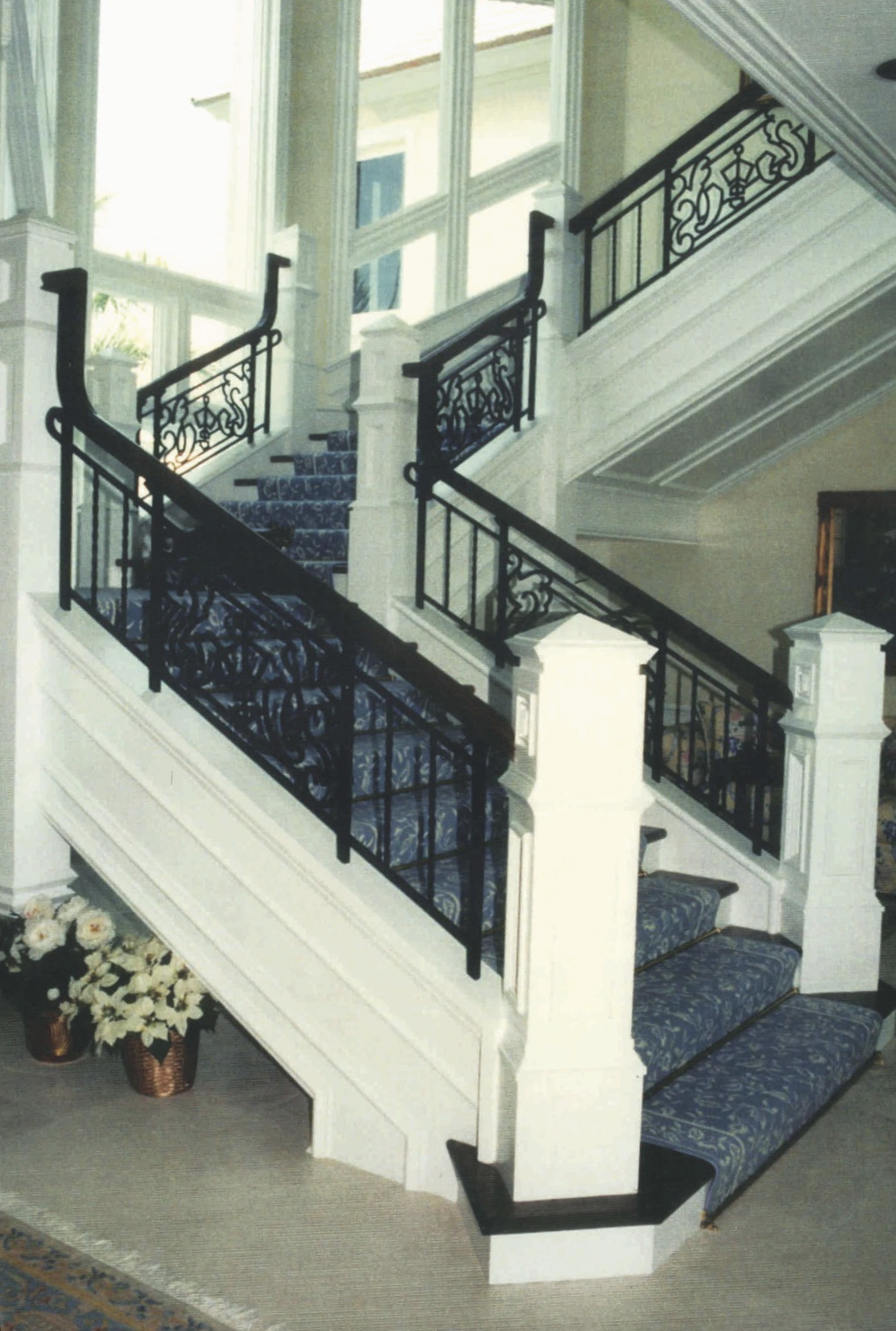 7' wide grand staircase using painted wood and iron with<br />monumental newels, three flights, two landings,  approx. 50'<br />horizontal railings/balustrade - Sailfish Point