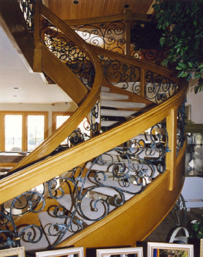 Reworked staircase and rail system, from black lacquer and lucite<br />to faux wood finish and custom iron work - Palm City